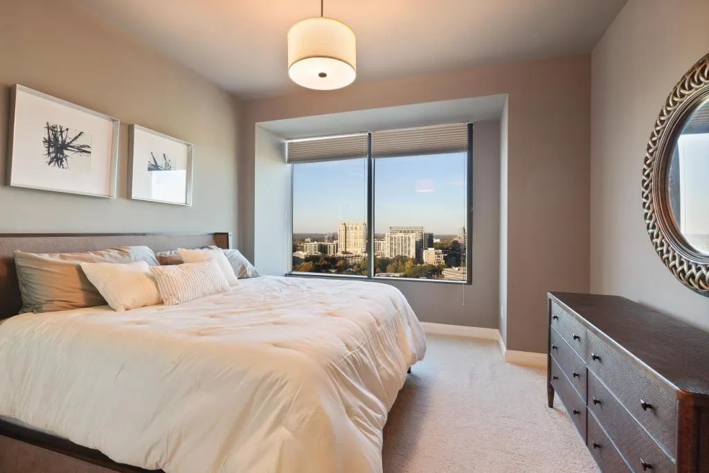 Bedroom with light colored carpet