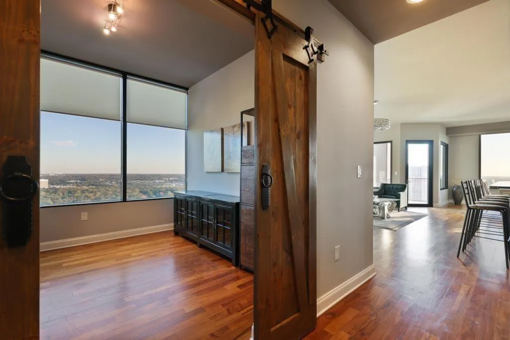 Corridor featuring hardwood / wood-style flooring and a barn door