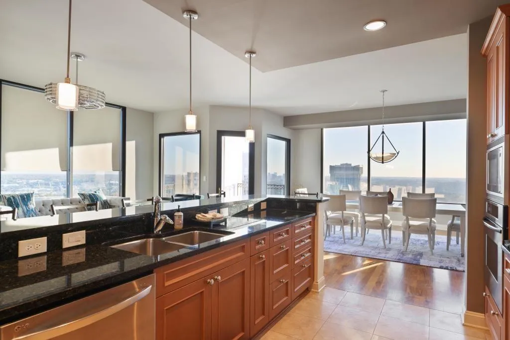 Kitchen featuring stainless steel appliances, pendant lighting, sink, and light hardwood / wood-style flooring