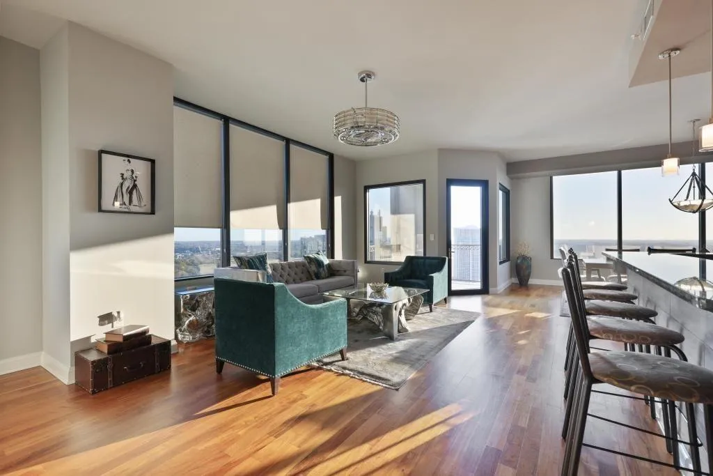 Living room with hardwood / wood-style flooring and a chandelier