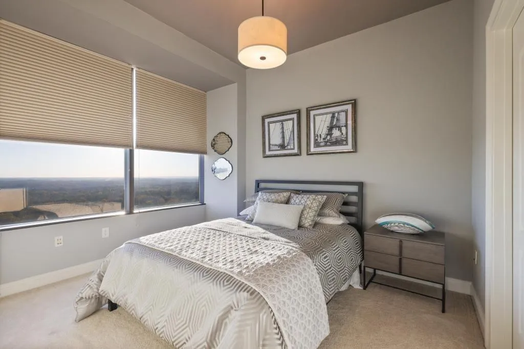 Bedroom featuring light carpet