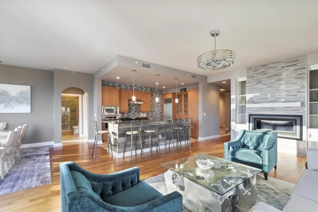 Living room with a fireplace and light wood-type flooring
