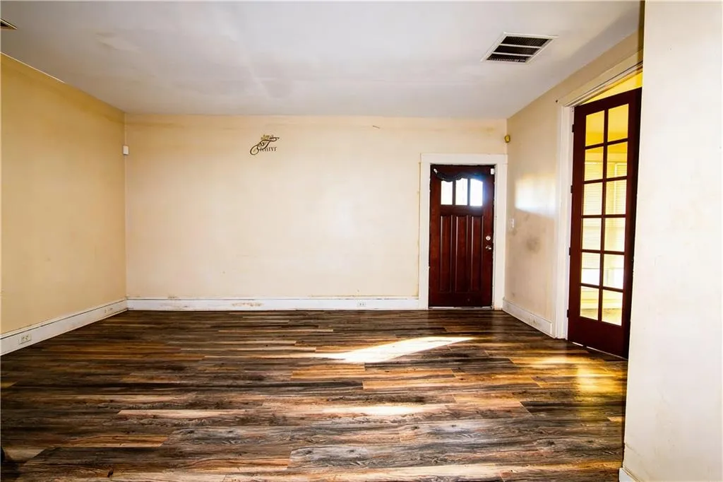 Entryway with dark wood-type flooring and baseboards