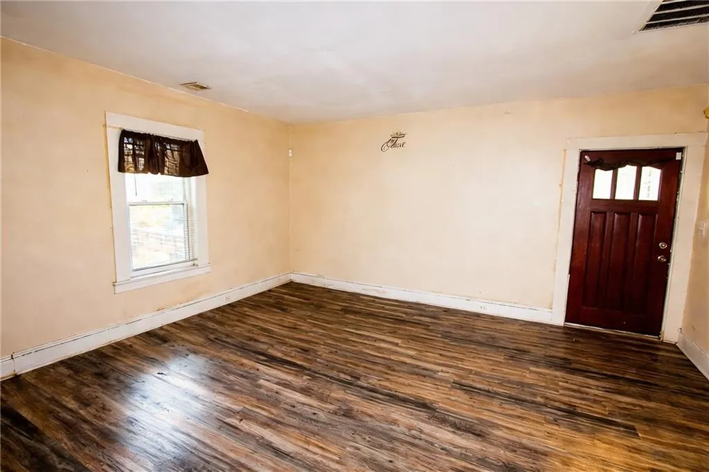 Entrance foyer featuring dark wood finished floors and baseboards