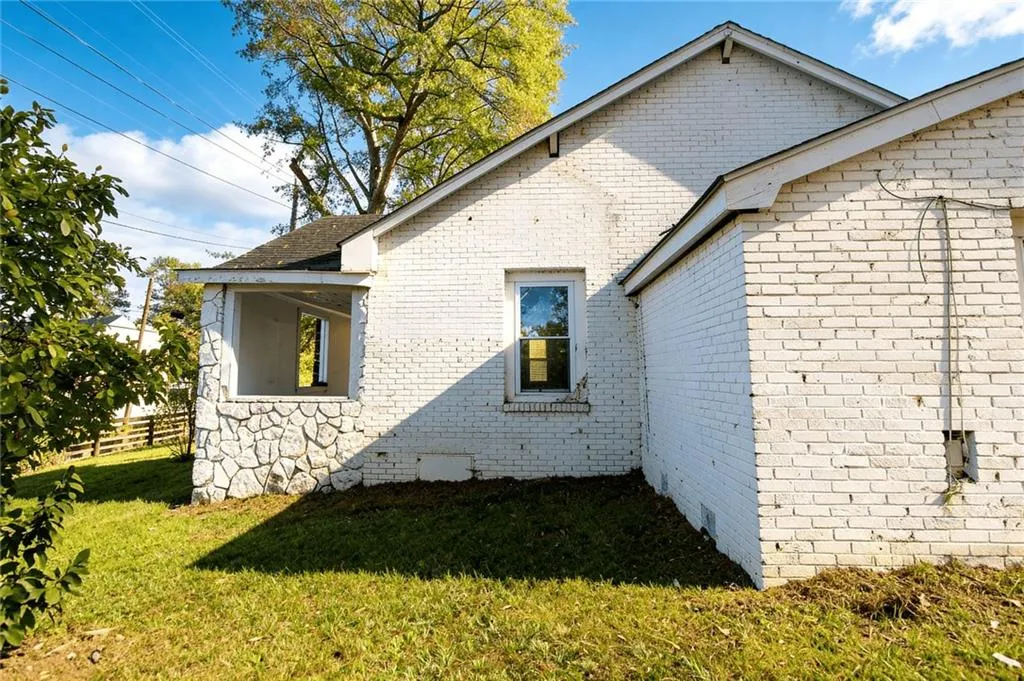 View of side of home featuring brick siding
