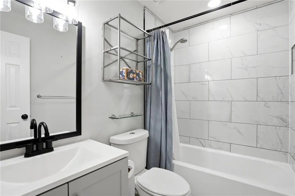 Full bathroom with vanity and shower / bath combo with shower curtain