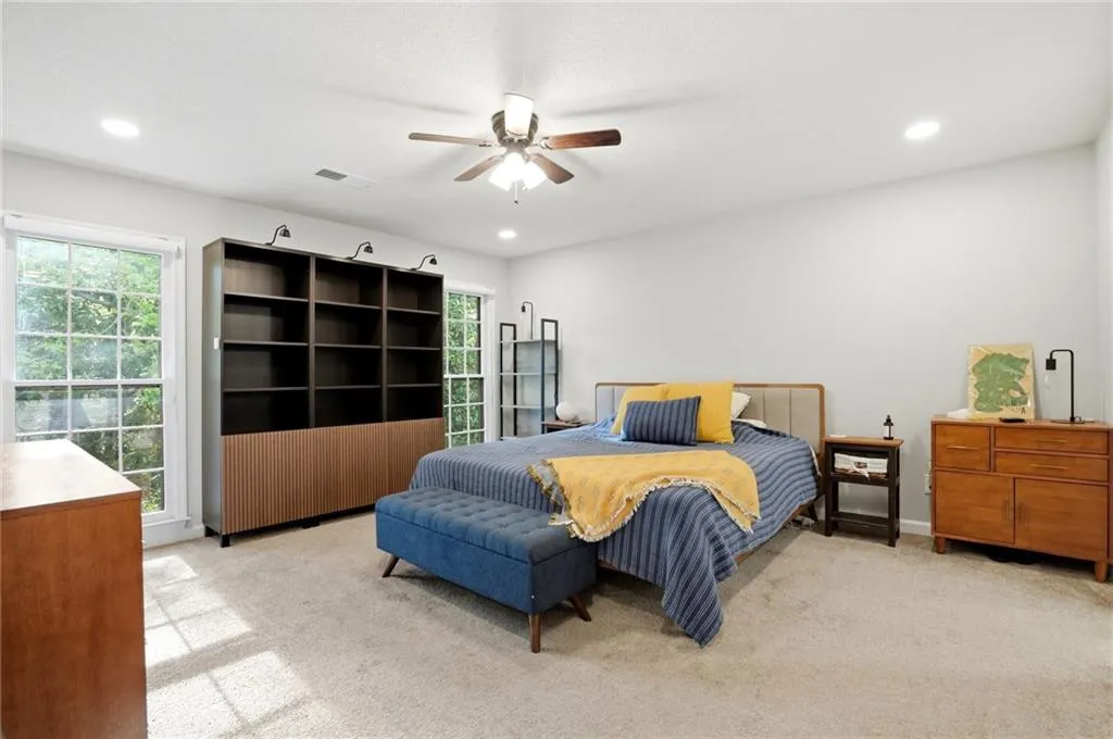 Bedroom featuring light carpet, recessed lighting, and a ceiling fan