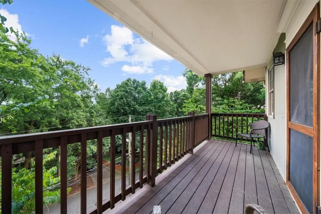 Wooden deck with view of wooded area