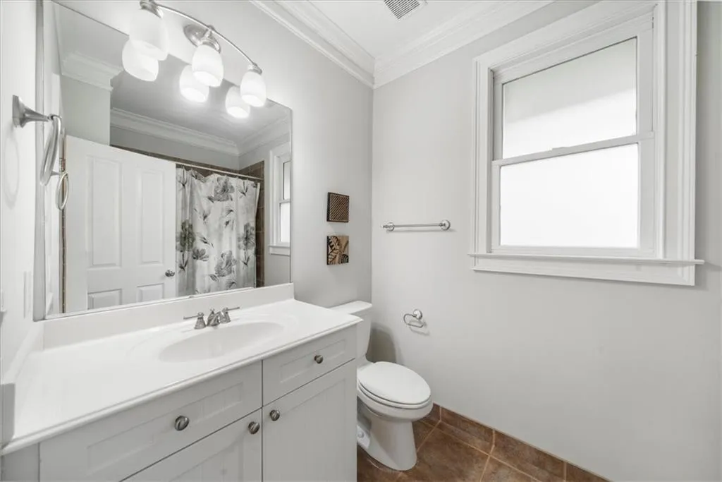 Bathroom with vanity, crown molding, tile patterned floors, and a shower with shower curtain
