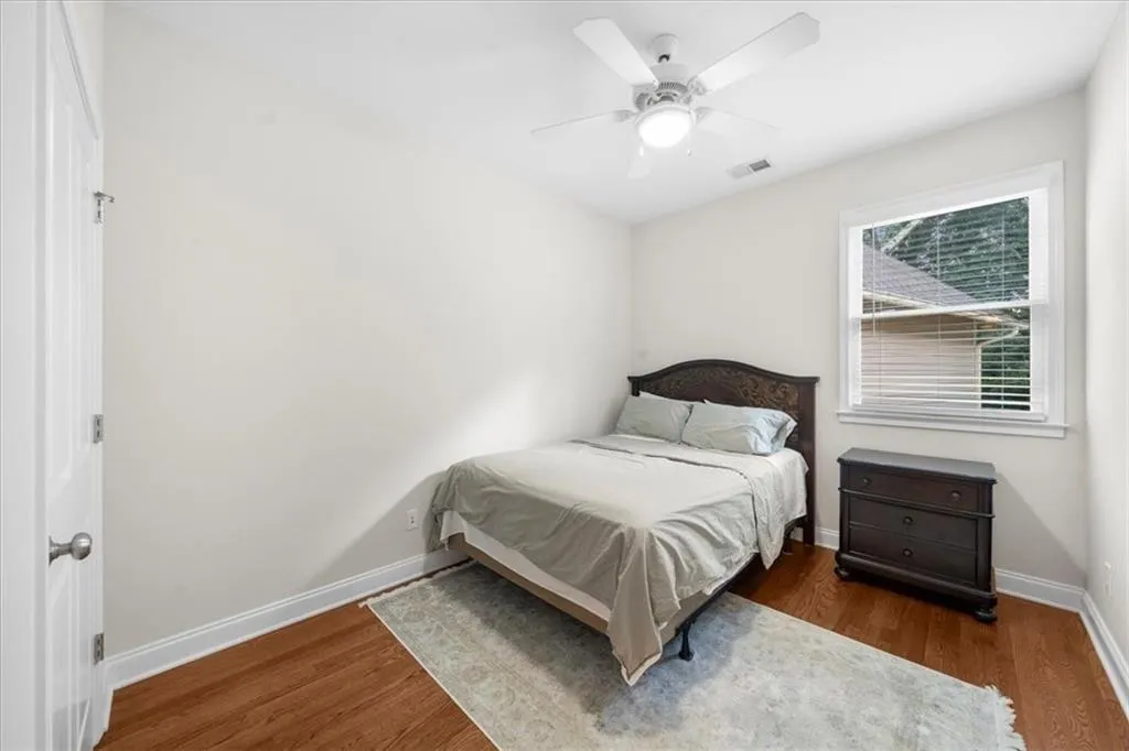 Bedroom featuring wood finished floors and a ceiling fan
