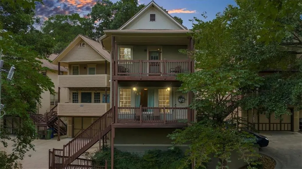 View of front facade featuring a balcony, stairs, and a porch