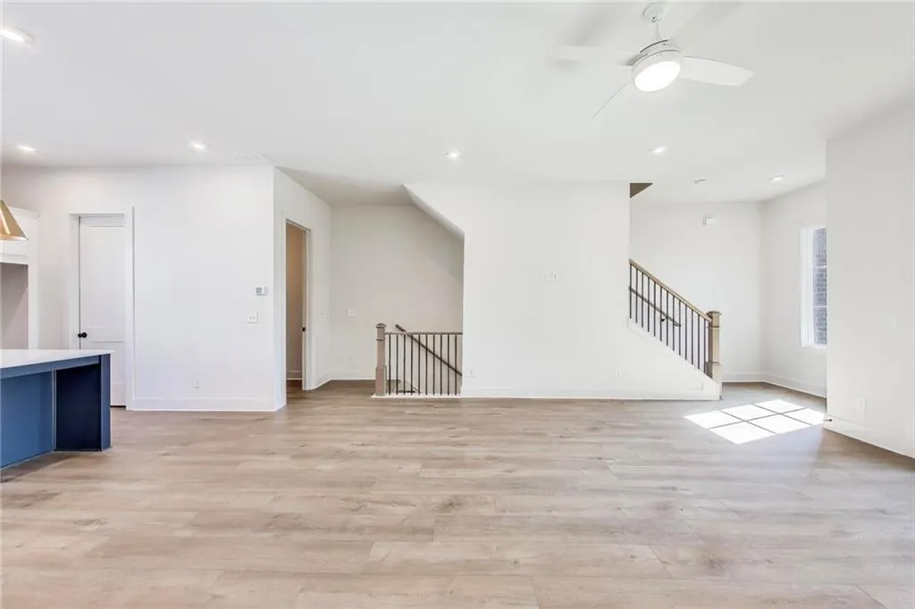 Additional living space with recessed lighting, light wood-style flooring, baseboards, and a ceiling fan