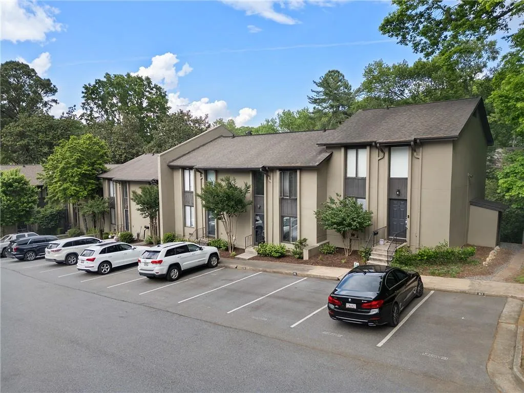 View of property featuring uncovered parking
