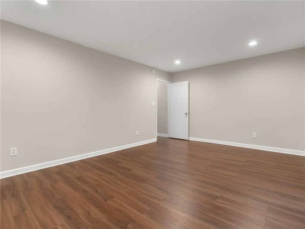 Unfurnished room featuring recessed lighting and dark wood-type flooring