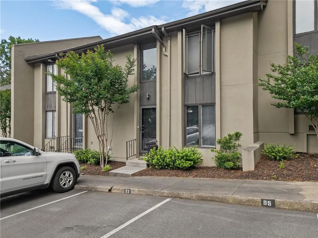 View of property with uncovered parking