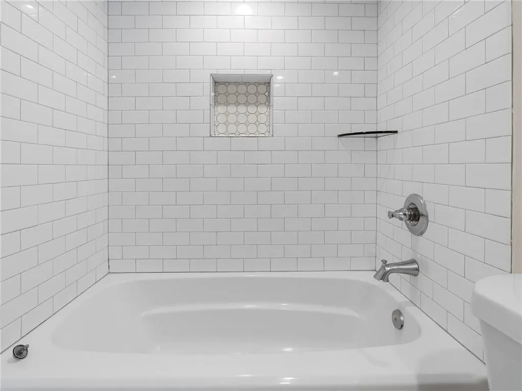 Full bathroom with toilet and shower / bath combination