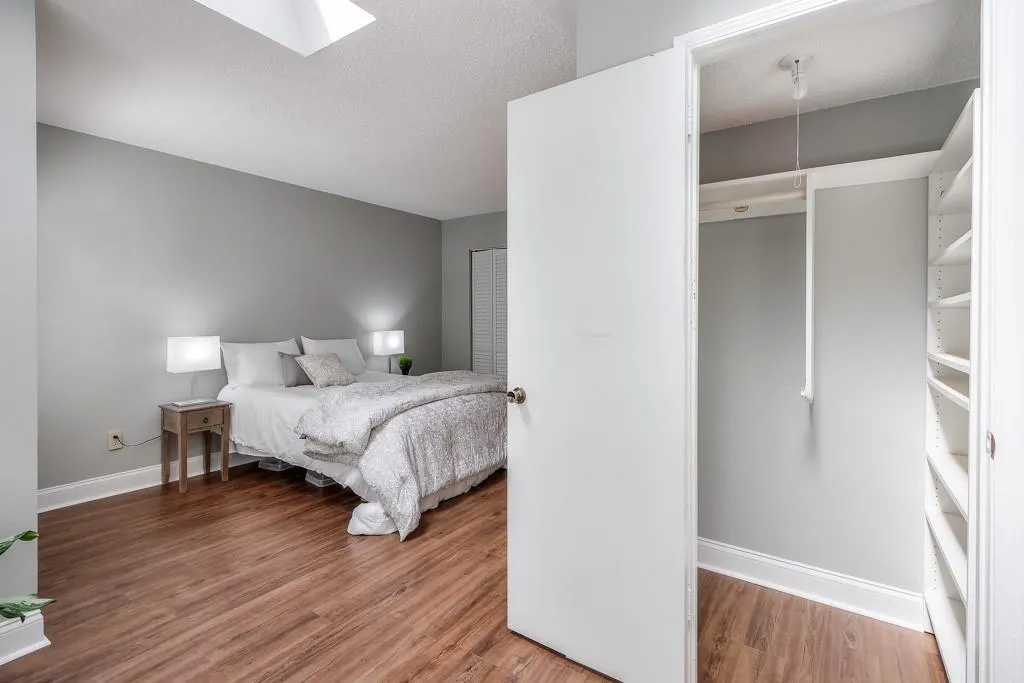 Large Primary Bedroom With NEW LVP Flooring, Skylight and One of Two Primary Closets
