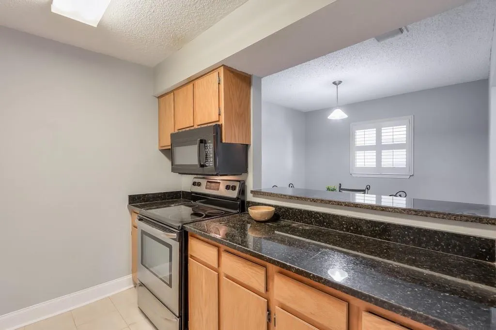 Granite Countertops, Beautiful Oak Cabinets and Tile Floors