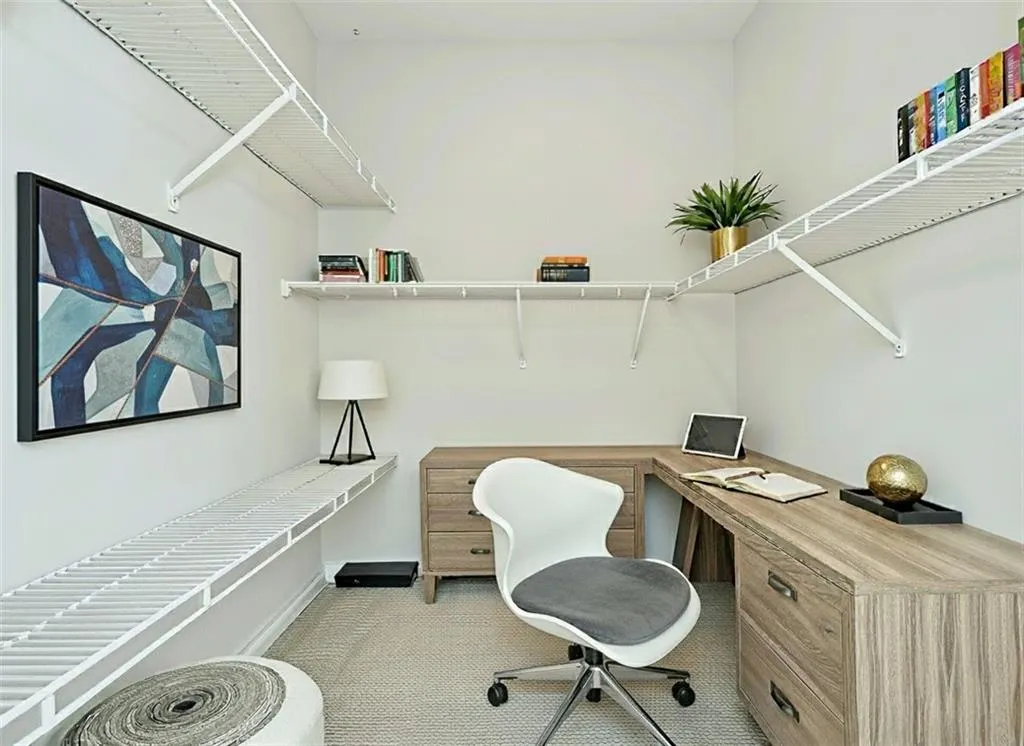 virtually staged walk in closet in bedroom to show you can easily set up as an office
