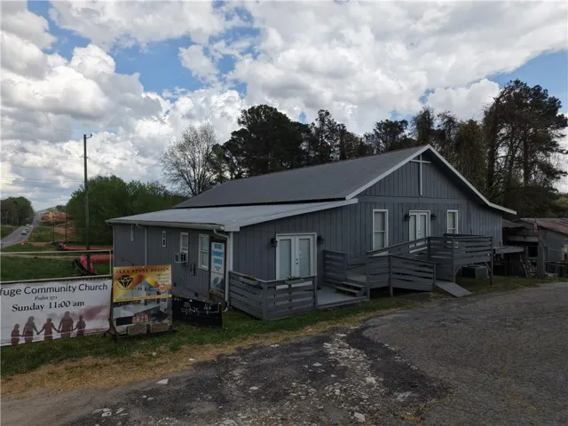 View of front facade with french doors and a metal roof