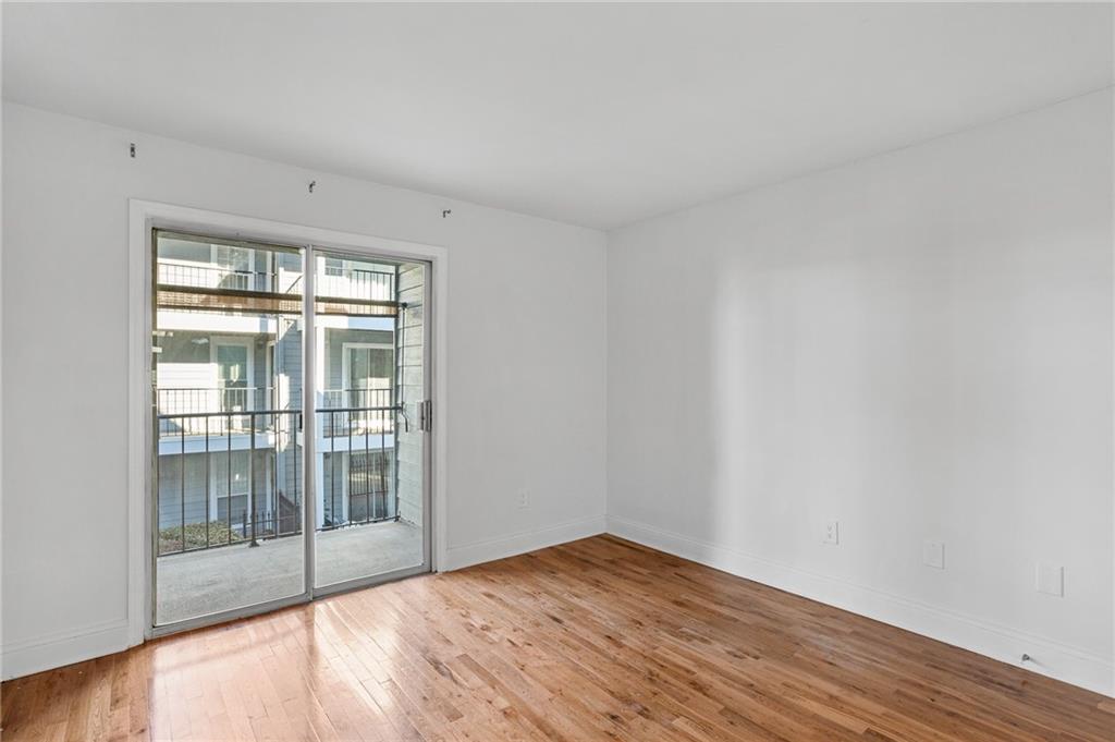 Empty room with light hardwood / wood-style flooring