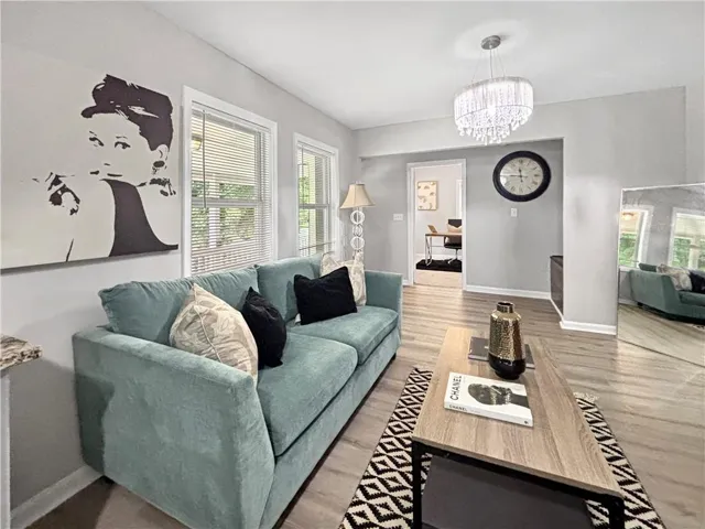 Light gray wall paint, wood-finish flooring, and white trim