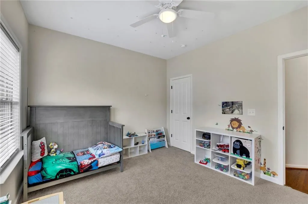 Carpeted bedroom featuring ceiling fan Carpeted bedroom featuring ceiling fan