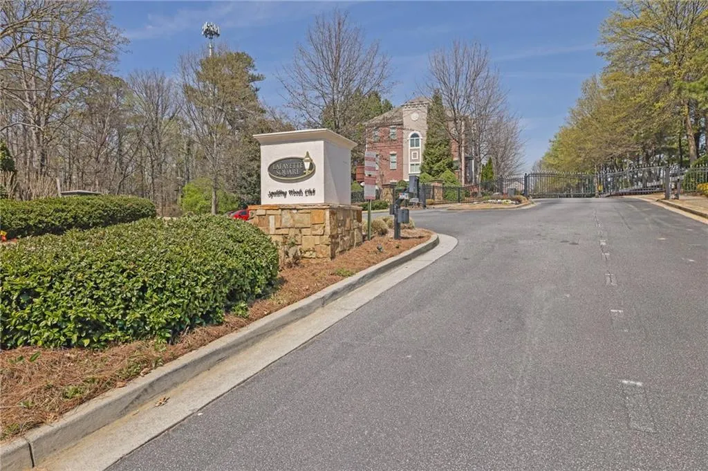 View of street featuring a gate, a gated entry, and curbs View of street featuring a gate, a gated entry, and curbs