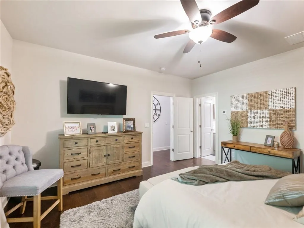 Bedroom featuring dark wood-style flooring, a ceiling fan, and baseboards