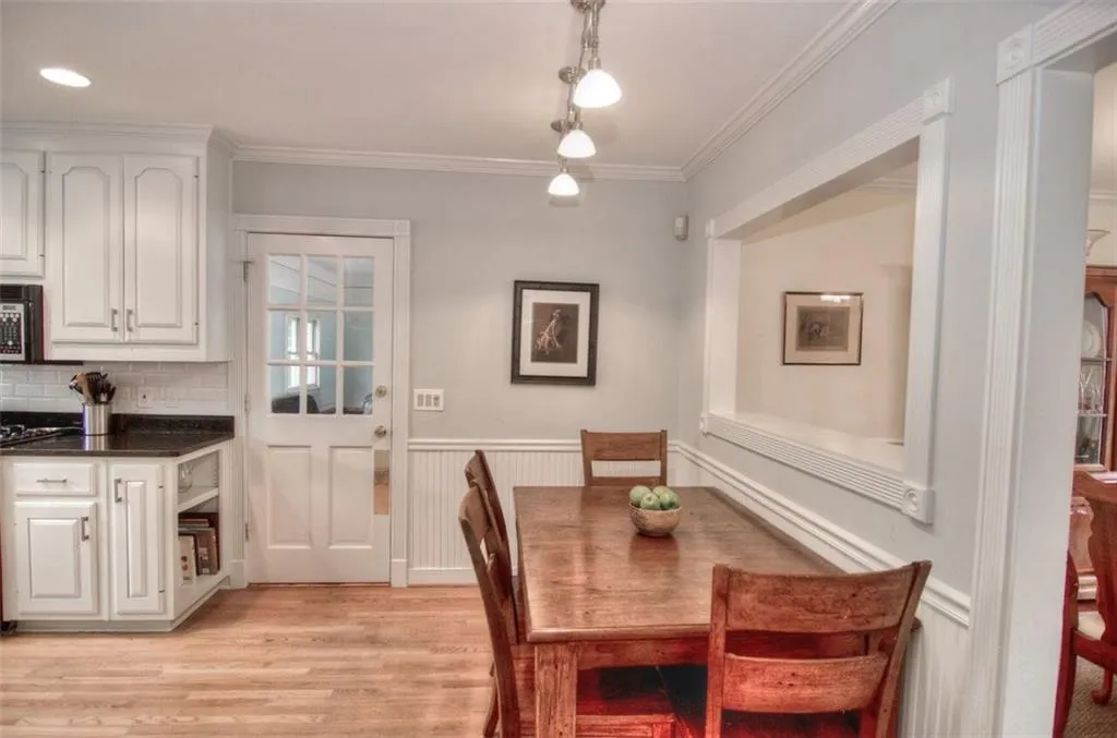 Dining area in kitchen with beadboard and handsome mouldings