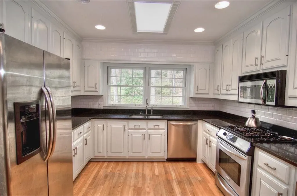 Recently renovated kitchen with stainless steel appliances, granite countertops and subway tile backsplash. Easy access from garage.