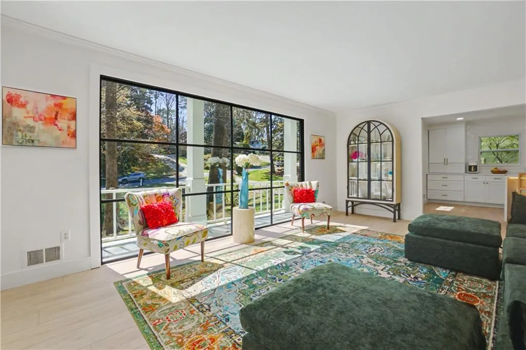 Living area with light wood finished floors and ornamental molding