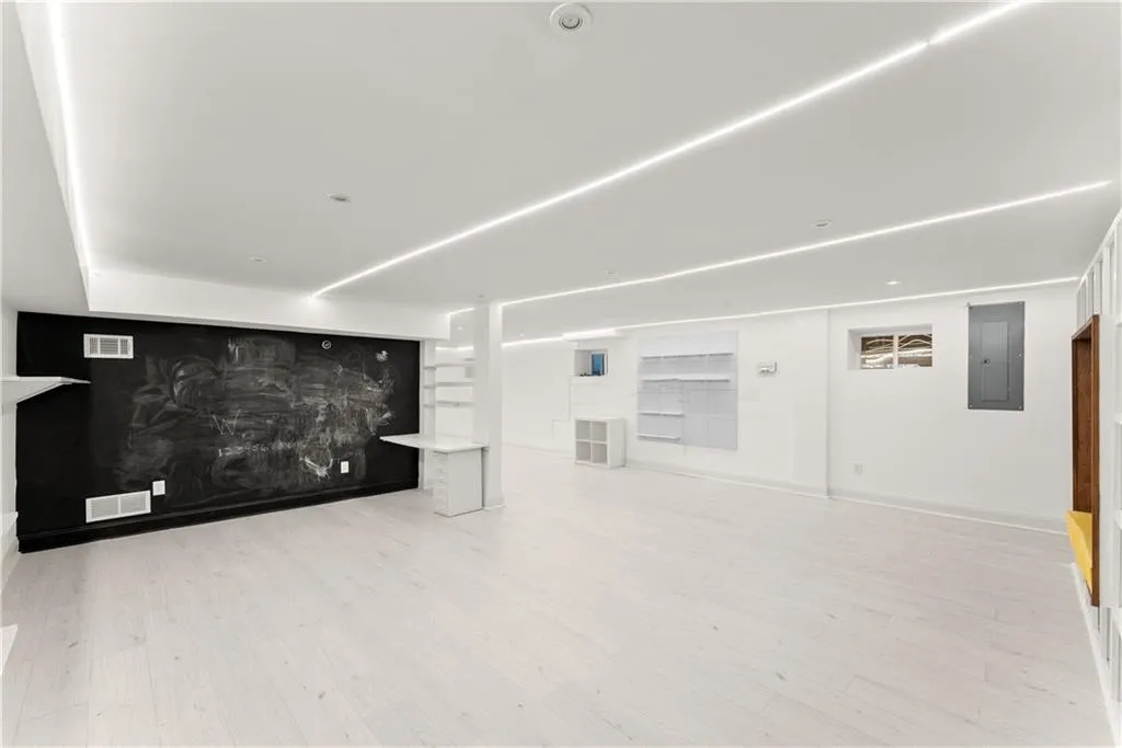 Unfurnished living room with light wood-style floors and electric panel