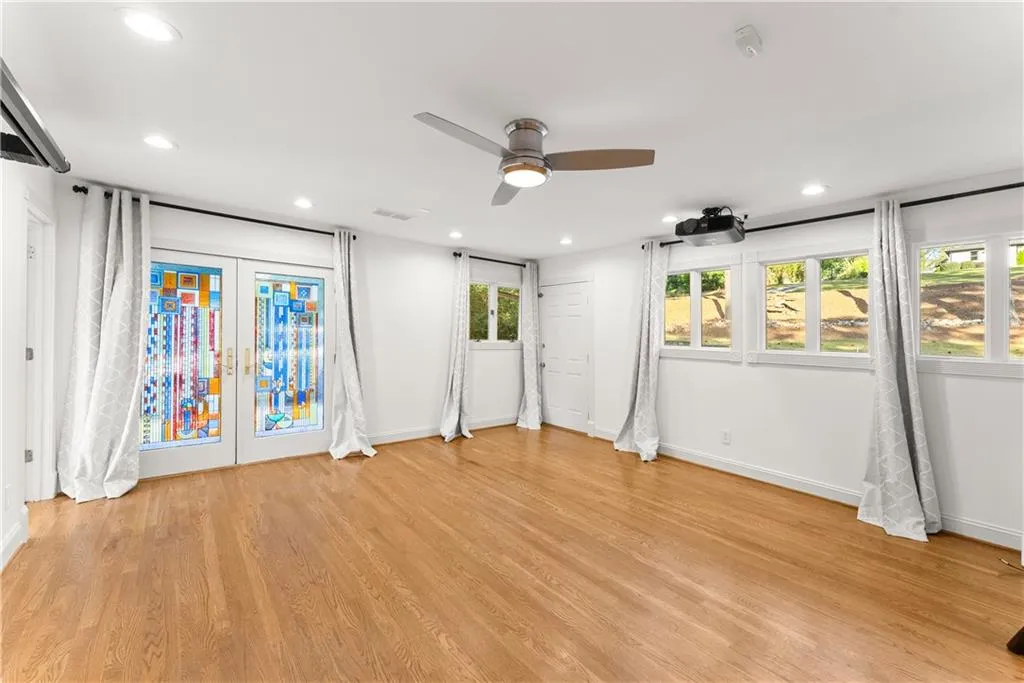 Master bedroom featuring french doors, access to outside, light wood-style flooring, a ceiling fan, and recessed lighting