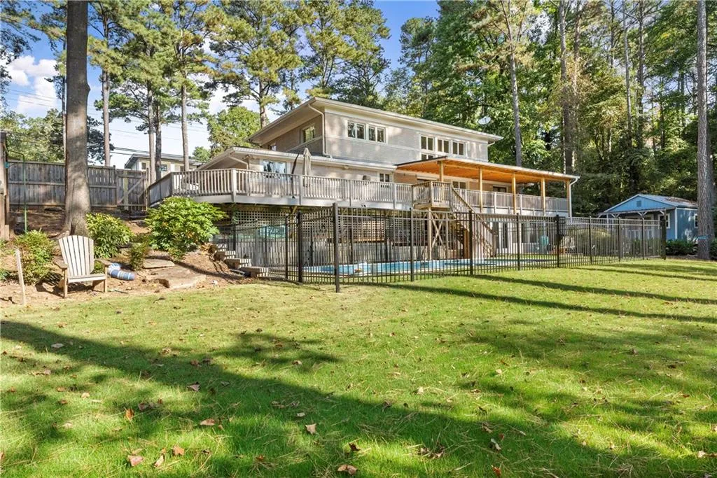 Back of house with stairs and a wooden deck