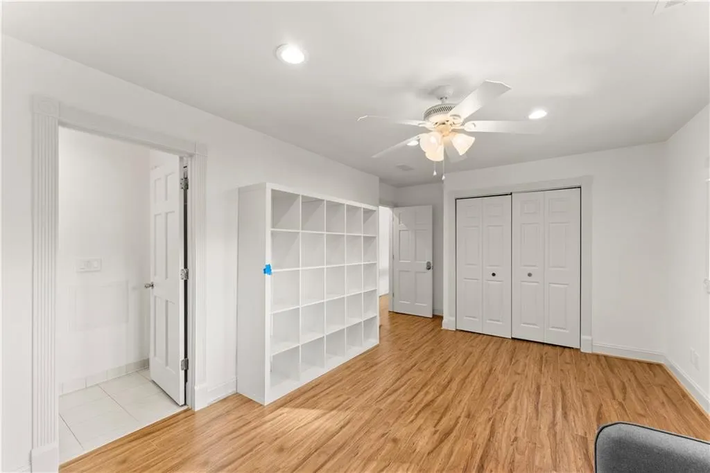 Unfurnished bedroom with light wood finished floors, a closet, a ceiling fan, and recessed lighting