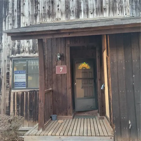 Entrance to property featuring board and batten siding