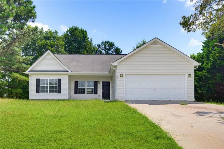 Ranch-style exterior featuring light-colored siding, a dark asphalt shingle roof, and a two-car garage