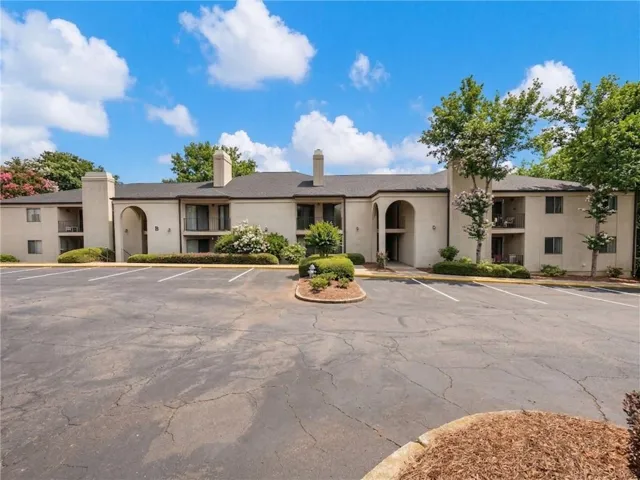 View of property with uncovered parking