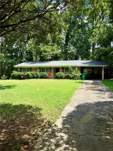 Brick-clad exterior with a dark roof and a covered carport
