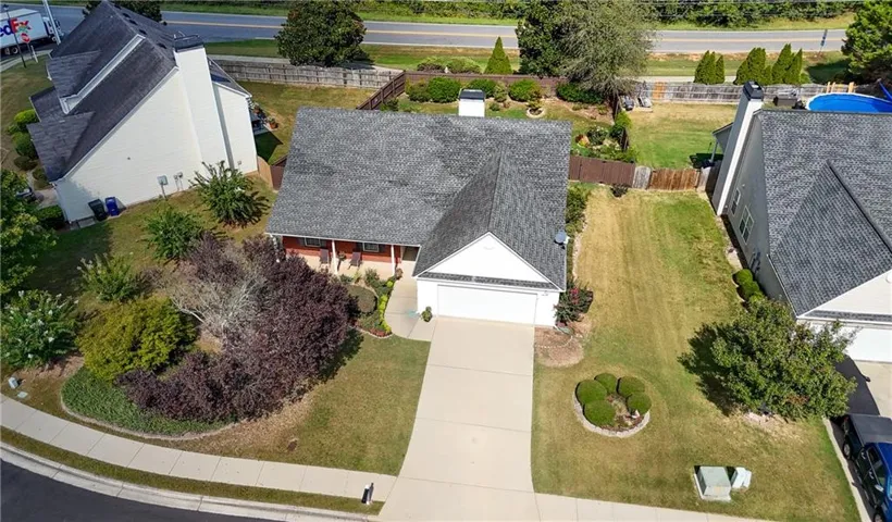 Single-story residence with an attached two-car garage, concrete driveway, and front porch