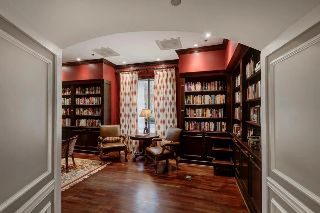 Wood paneled library with 800 books and daily newspapers
