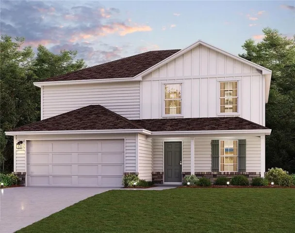 View of front of property with a front lawn, concrete driveway, and board and batten siding