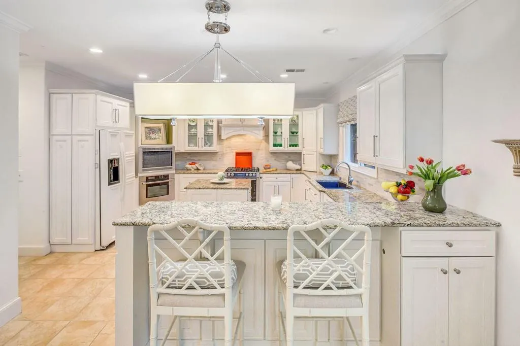 Primary bath with stackable washer and dryer behind tall cabinet