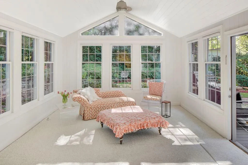 2 story living room with  french doors and limestone gas fireplace