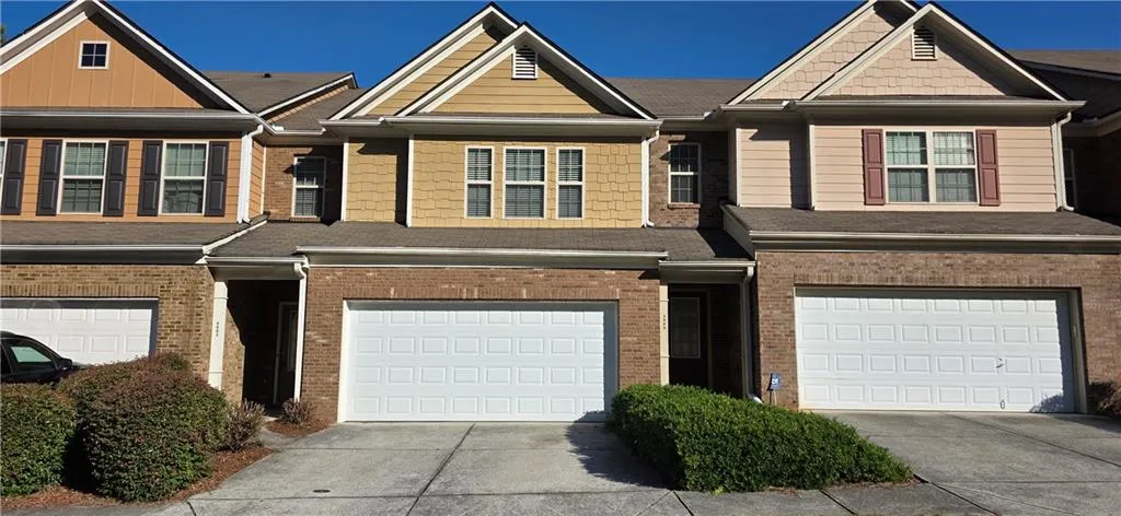 Brick and siding exterior with gabled roofline and attached garage