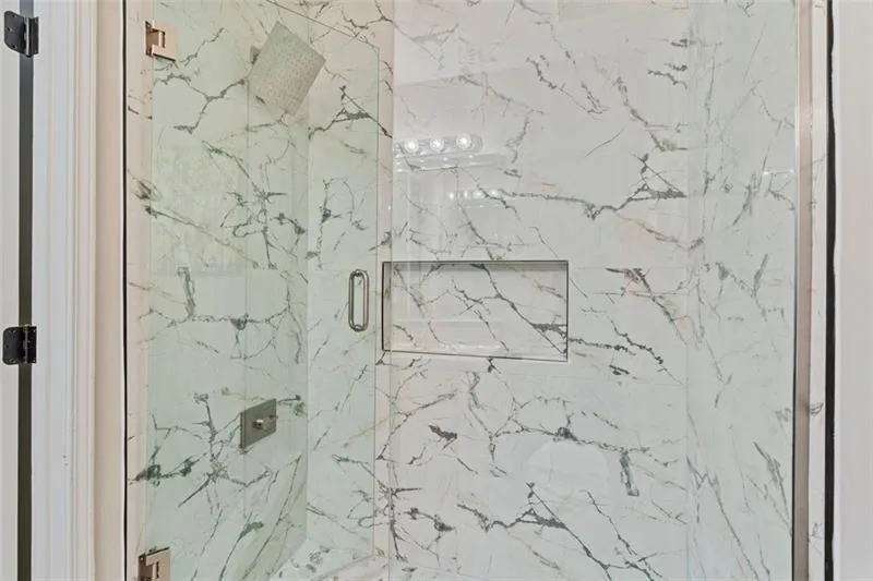 Full bathroom featuring a marble finish shower Full bathroom featuring a marble finish shower