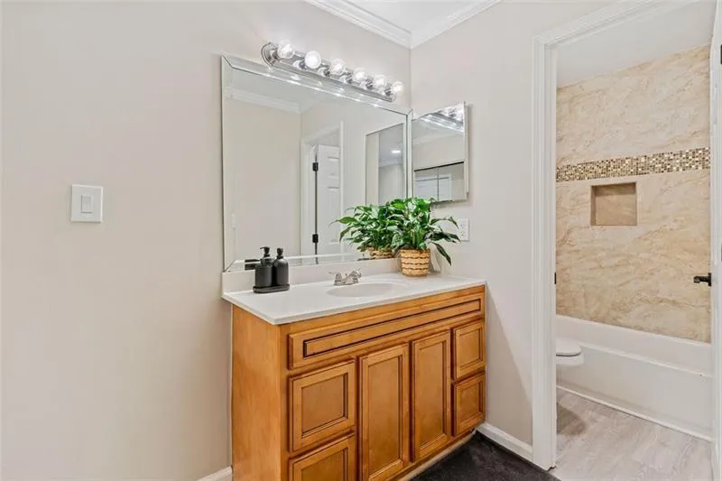 Full bath with vanity, crown molding, and  shower combination Full bath with vanity, crown molding, and  shower combination