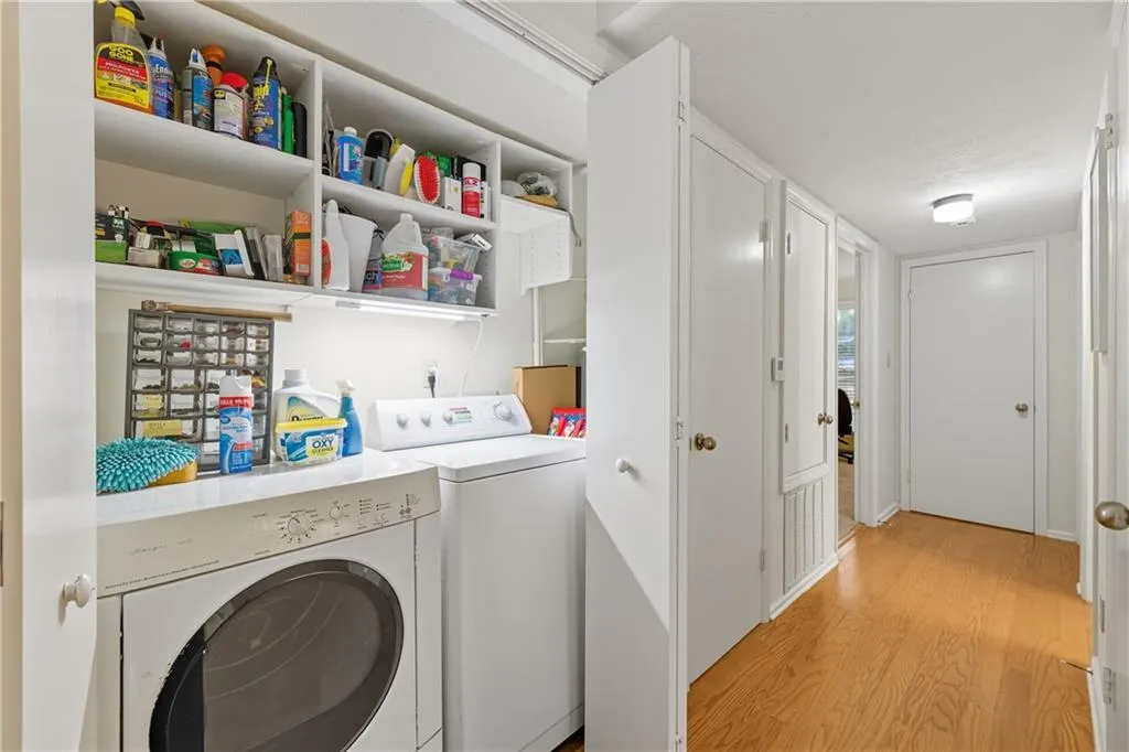Laundry area featuring light wood-style floors and washer and dryer