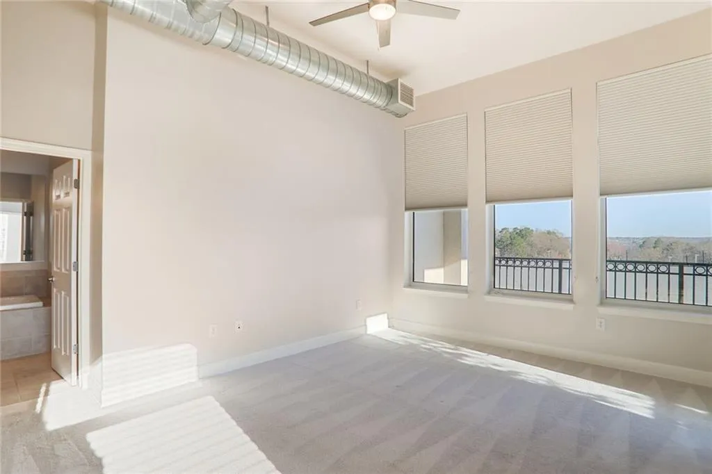 Empty room featuring baseboards, carpet, and ceiling fan